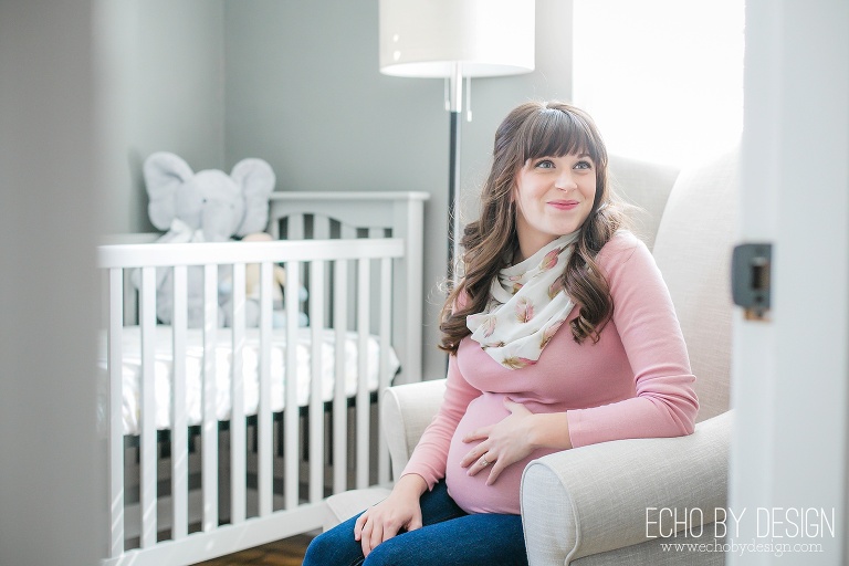 Mom sits in nursery during Maternity Photos