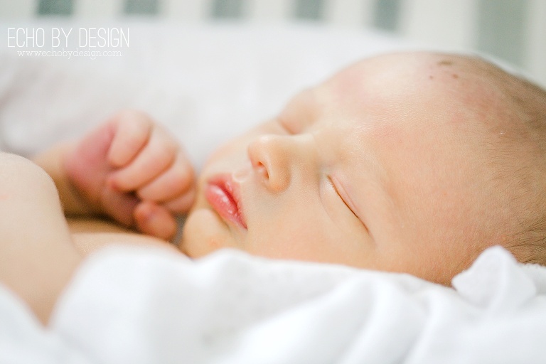 Lifestyle portrait of newborn boy in blanket