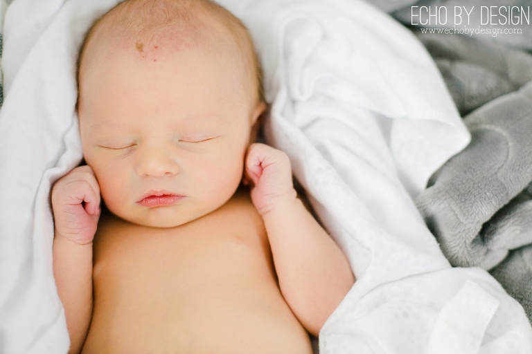 Lifestyle photo of newborn boy in blanket