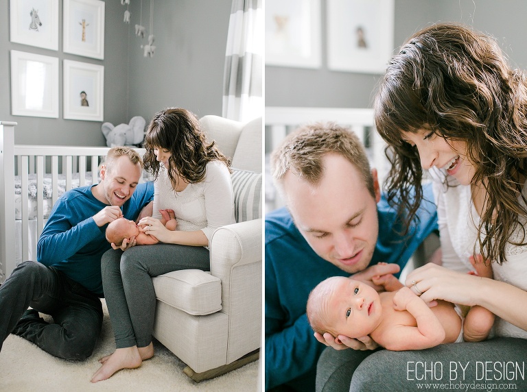 Mom and Dad hold newborn baby in zoo animal nursery