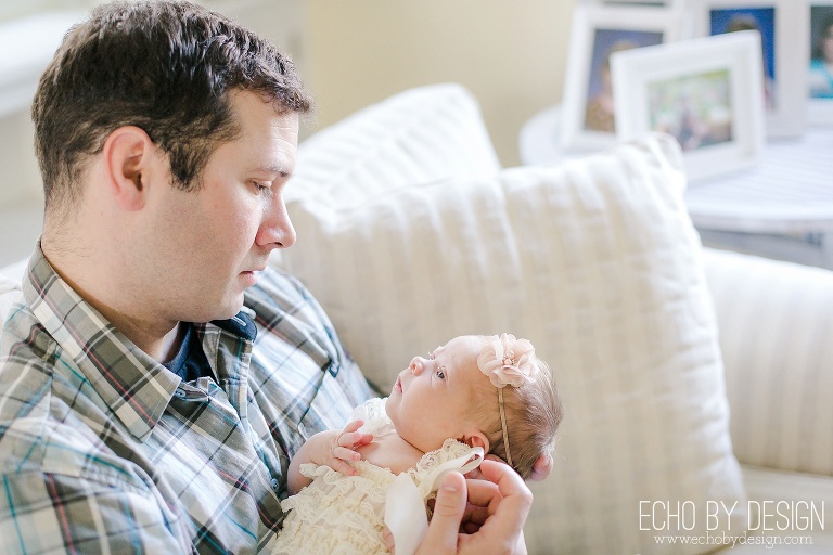 Dad talks to newborn baby girl in Lifestyle Session
